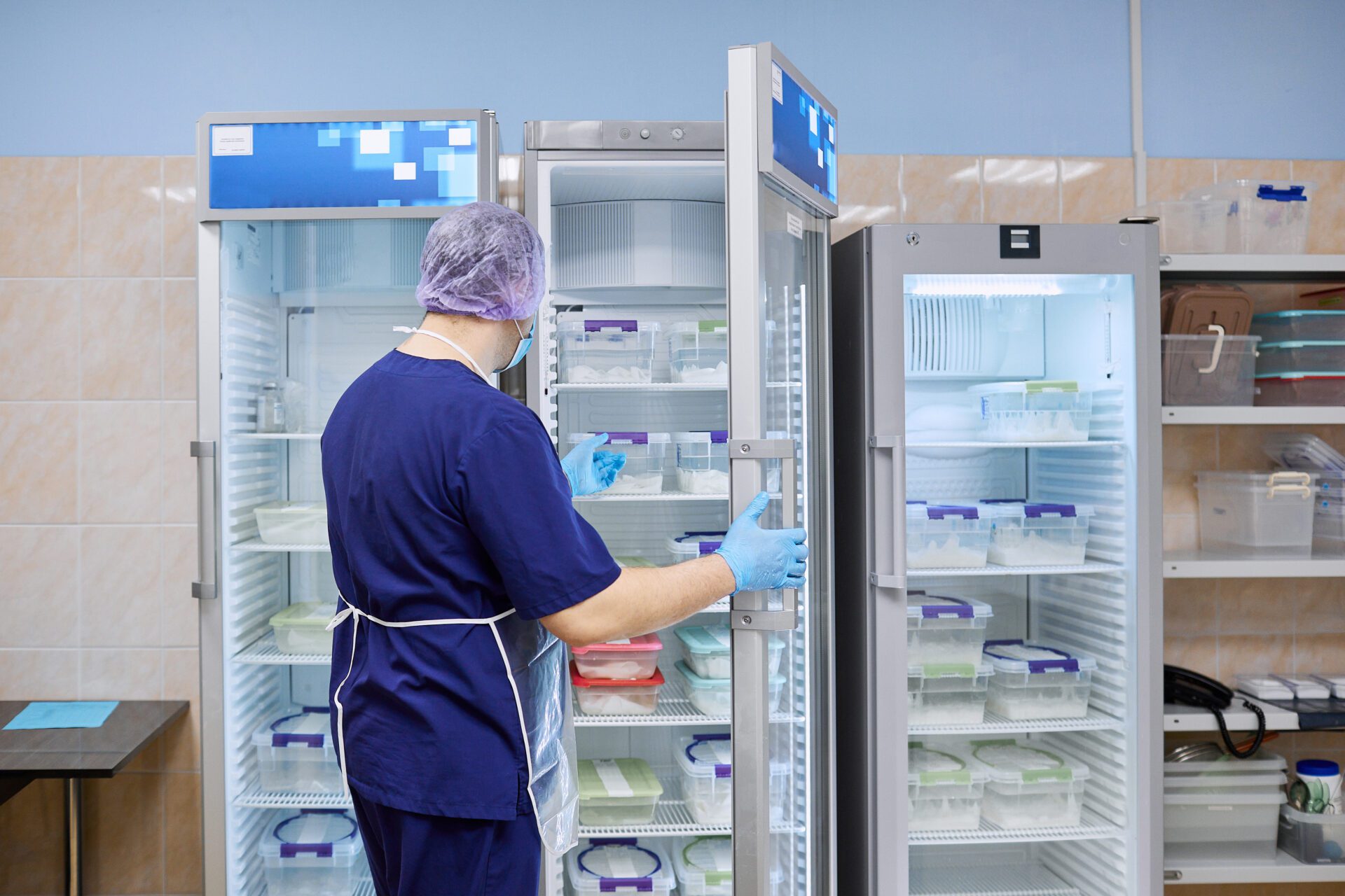The scientist takes samples of materials for experiments out of the refrigerator